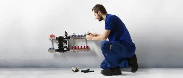 Installer installing a radiator