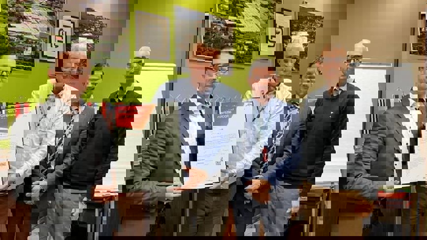 A group of men celebrating obtaining Purmo green steel certificate