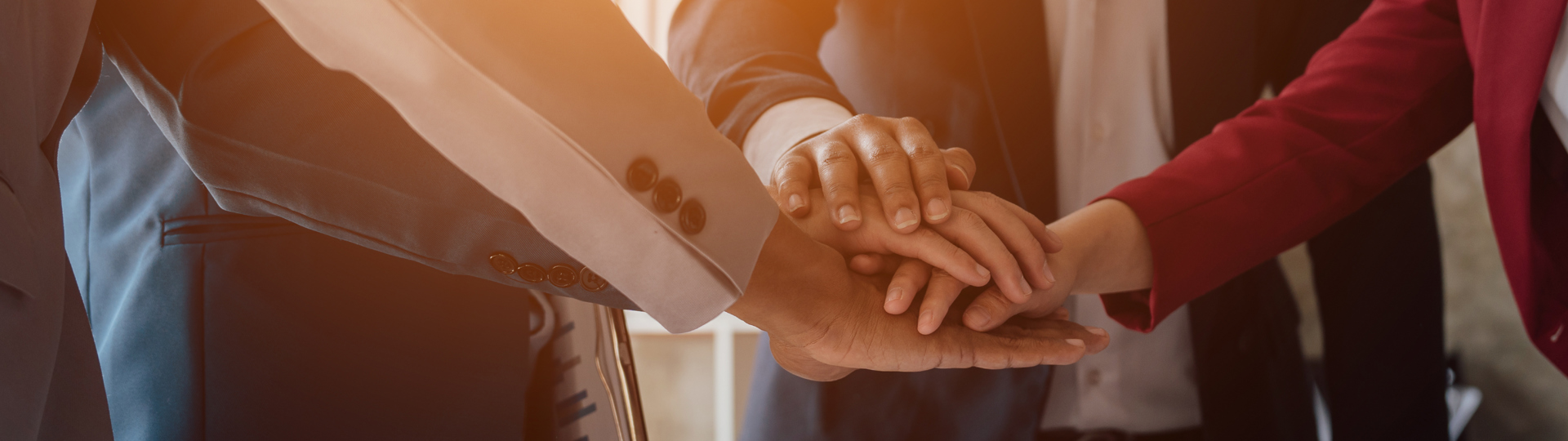 Silhouette of an adult and a child against a backdrop of a landscape with wind turbines